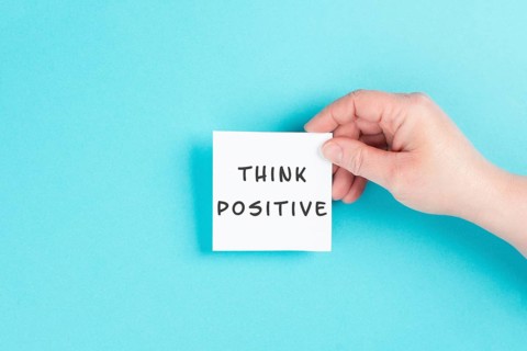 The words think positive are standing on a paper, optimistic mindset, coaching and motivation
