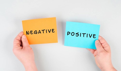 The words negative and positive are standing on paper, business and service rating, evaluation