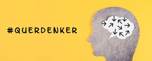 Think different stands in german language on the yellow background, head with brain, being a