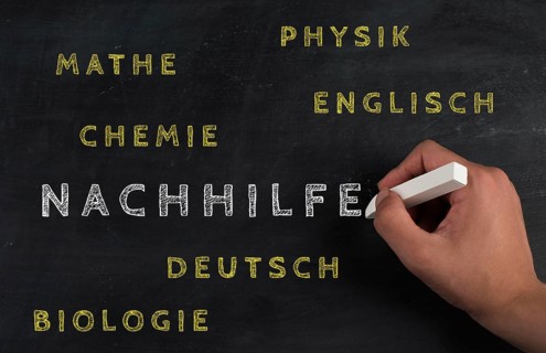 The word for private tutoring is standing in german language on a chalkboard, help for students in