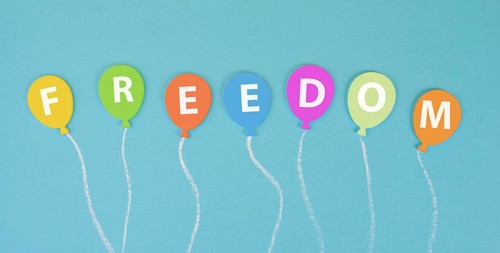 The word freedom is standing on ballons, new normal, covid-19 regulations, changing lifestyle, free