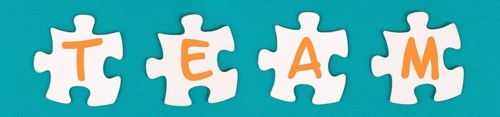 The word team is standing on puzzle pieces, connect the parts together, corporate in teamwork,