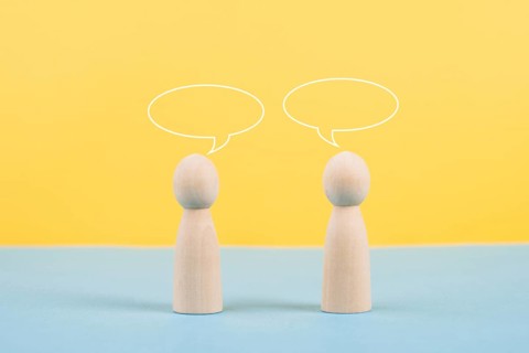 Two people talking together, empty speech bubbles, having a conversation, networking and teamwork