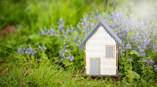 Wooden house in a meadow, buying or renting a house in nature, real estate concept, booking home
