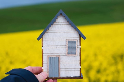 Wooden house in a meadow, buying or renting a house in nature, real estate concept, booking home
