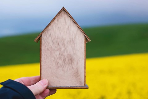 Wooden house in a meadow, buying or renting a house in nature, real estate concept, booking home