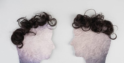 Silhouette of two faces with hair looking to each other, communication, having an opinion and