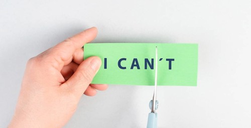 The word can not is standing on a paper, cutting the not with scissors, having a goal, postive
