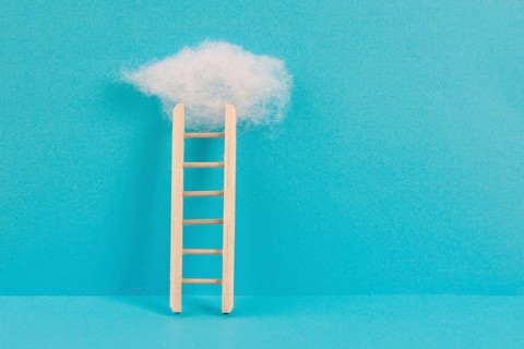 Ladder with a cloud on top, blue colored background, copy space, dreaming of success, creative and
