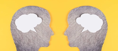 Silhouette of two faces, speech bubble in white color, copy space for text, communication, having
