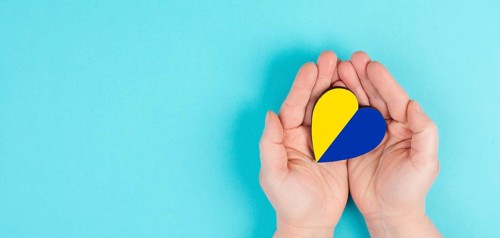Holding a heart with the flag of Ukraine, national idendity, war crisis between Ukraine and Russia,