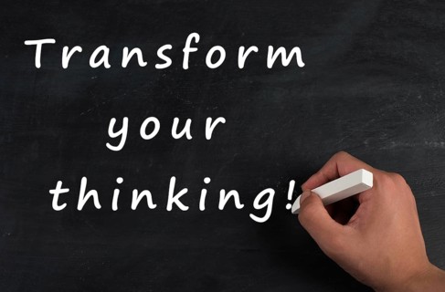 The phrase transform your thinking is standing on a chalkboard, change the mindset, strategy and