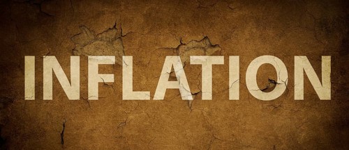 The word inflation is standing on a brown textured wall, increasing living costs