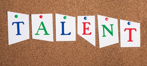 The word talent is standing in colorful letters on a corkboard, unique skill, having a passion,