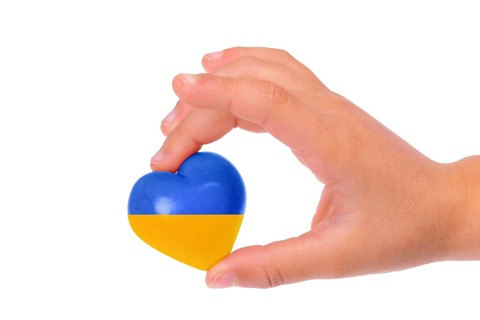 Holding a heart with the flag of Ukraine, national idendity, war crisis between Ukraine and Russia,
