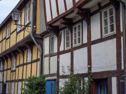 Traditional half-timbered houses with a street lamp and flowers on the facades, Detmold, North