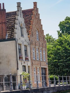 Historic brick houses with gables on a sunny day near a canal, Bruges, Flanders, Belgium, Europe