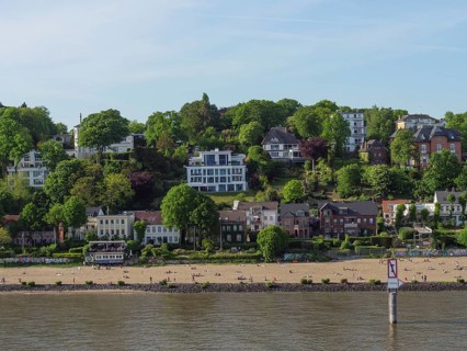 Beach view with buildings behind and a lot of green landscape on the shore, Elbe, Hamburg, Northern