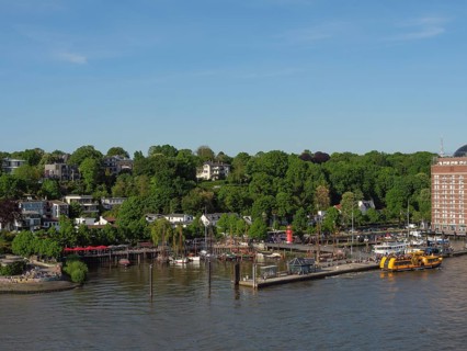 Idyllic harbour view with boats and surrounding buildings, surrounded by greenery, Elbe, Hamburg,