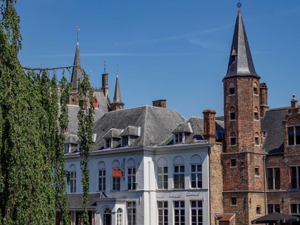 Historic city centre with characteristic architectural towers and brick buildings under a clear