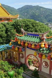 Traditional Chinese architecture surrounded by green mountains and colourful lanterns, Pattaya,