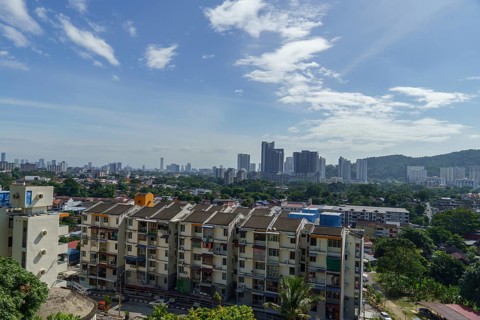 View of a city with modern skyscrapers and residential buildings under a cloudy sky, Pattaya,