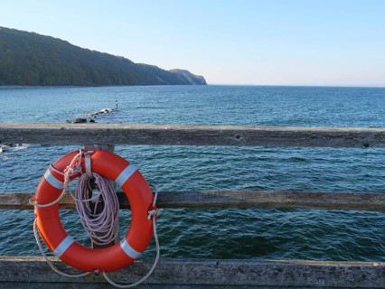 Lifebuoy on a pier with a view of the wide sea and the coast, Binz, Rügen, Germany, Europe
