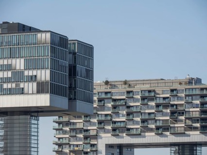 Modern high-rise buildings with glass facades in an urban environment under a clear sky, Cologne,