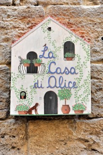 Volterra, Tuscany, Italy, Europe, Decorative hand-painted sign 'La Casa di Alice' on a stone wall