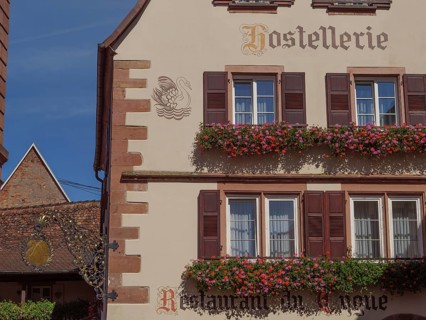 A traditional restaurant in a historic half-timbered house, decorated with flowers and a coat of
