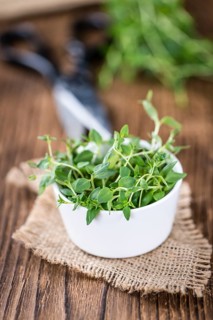 Fresh Thyme (close-up shot, selective focus) on wooden background