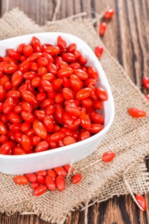 Some fresh Goji Berries (also known as Wolfberry) on vintage wooden background