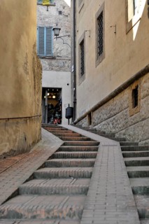 Volterra, Tuscany, Italy, Europe, A narrow alley in an old town centre leads up steps to an open