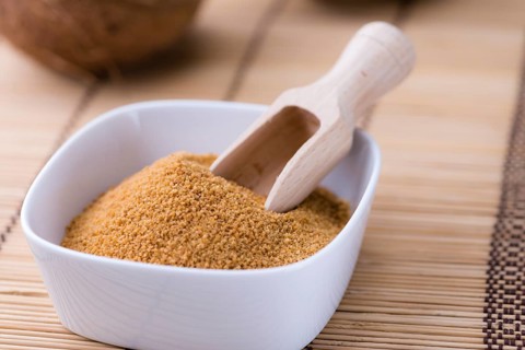 Portion of Coco Sugar (selective focus) on a vintage wooden table