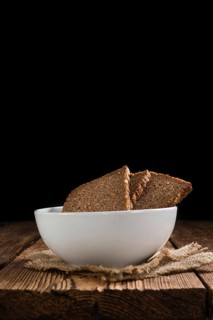 Slices of Brown Bread (selective focus) on an old wooden table