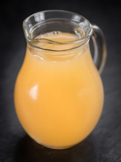 Portion of Juice (apple) on a rustic slate slab (selective focus, close-up shot)