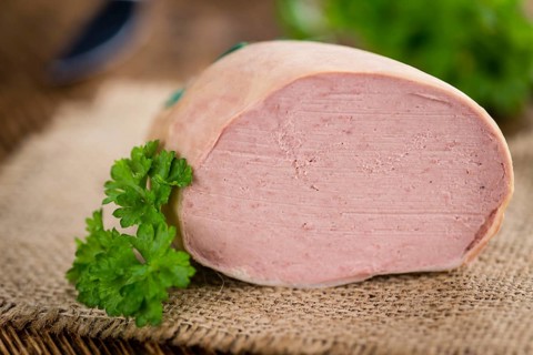 Liverwurst on a vintage background as detailed close-up shot (selective focus)