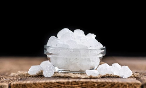 White Rock Candy on wooden background (detailed close-up shot, selective focus)
