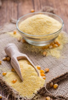 Portion of Cornmeal (on rustic background) as detailed close-up shot