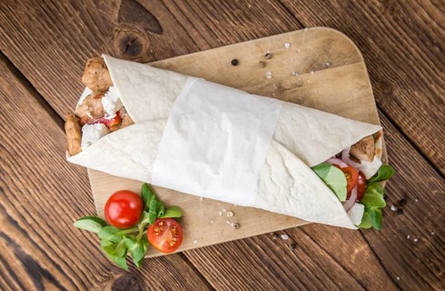 Homemade Chicken Wrap (close-up shot) on vintage background (selective focus)