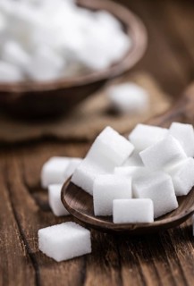 Old wooden table with white Sugar (selective focus, close-up shot)