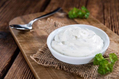 Fresh made Sour Cream (selective focus) on vintage wooden background