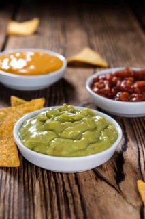 Different sorts of Nacho Dips (soft focus) on wooden background