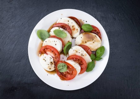 Tomatoes with Mozzarella and Balasimco dressing (selective focus)