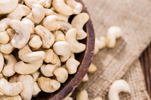 Portion of dried Cashew Nuts (detailed close-up shot)
