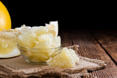 Fresh pieces of Pomelo (close-up shot) on vintage background