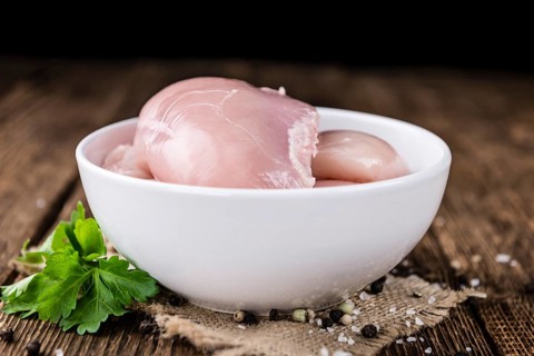 Fresh Chicken Fillet (selective focus, close-up shot) on vintage wooden background