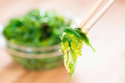 Kelp Salad (detailed close-up shot) on wooden background