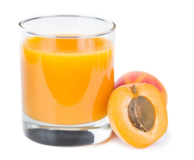 Fresh made Apricot Juice isolated on white background (close-up shot)
