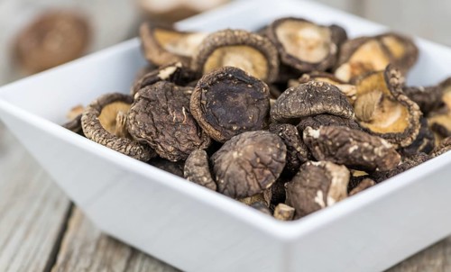 Dried Shiitake on a vintage background as detailed close-up shot, selective focus